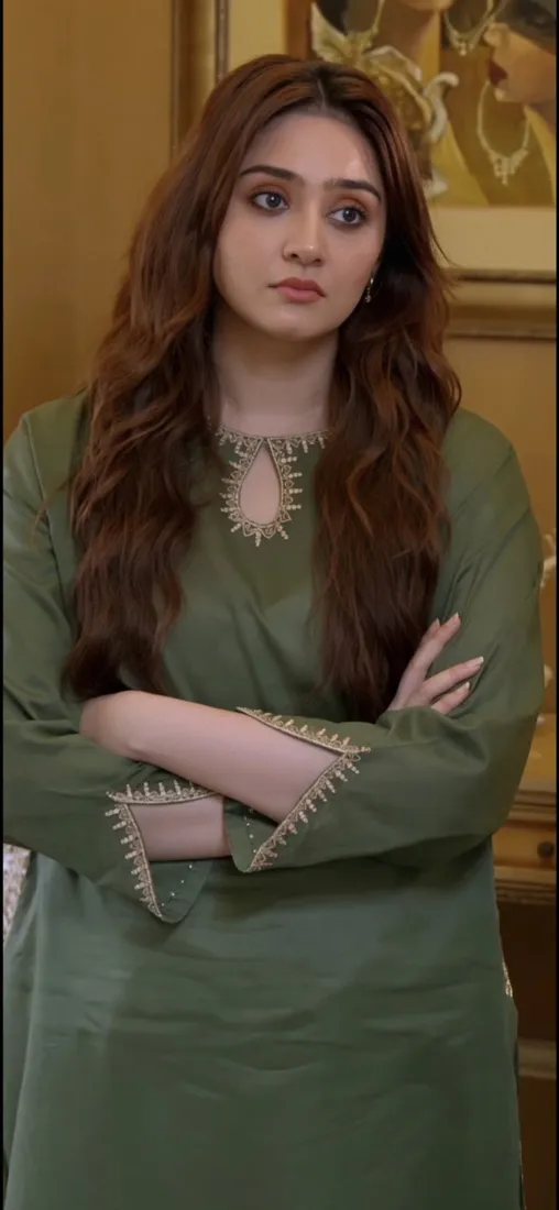 Durefishan Saleem in an olive-green outfit, looking toward the camera